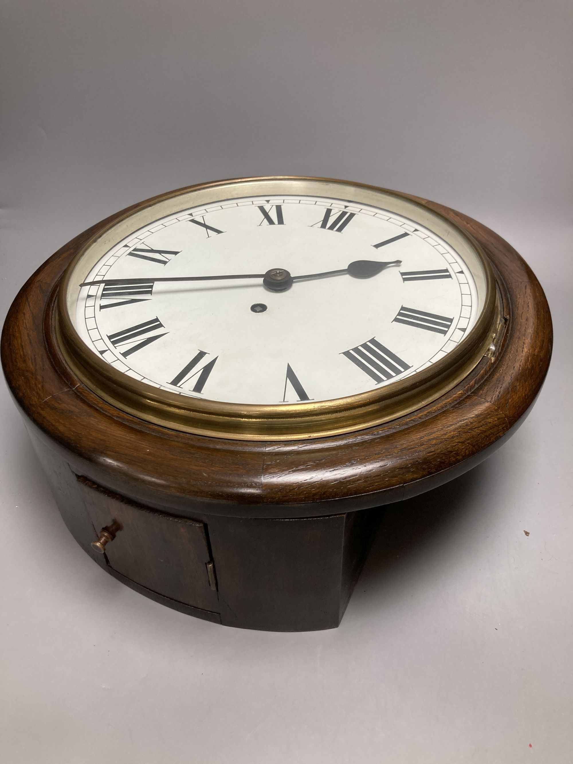 An oak cased single fusee dial wall clock, black Roman numerals on a white 12